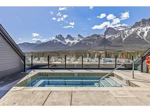 306-1315 Spring Creek Gate, Canmore, AB - Outdoor With In Ground Pool With View