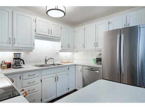 6-28 Berwick Crescent Nw, Calgary, AB - Indoor Photo Showing Kitchen With Stainless Steel Kitchen With Double Sink