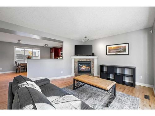 151 Somme Manor Sw, Calgary, AB - Indoor Photo Showing Living Room With Fireplace