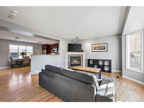 151 Somme Manor Sw, Calgary, AB - Indoor Photo Showing Living Room With Fireplace