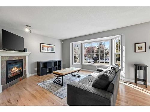 151 Somme Manor Sw, Calgary, AB - Indoor Photo Showing Living Room With Fireplace