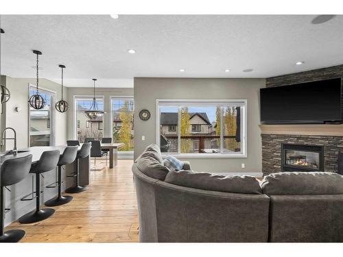 209 Hidden Creek Road Nw, Calgary, AB - Indoor Photo Showing Living Room With Fireplace