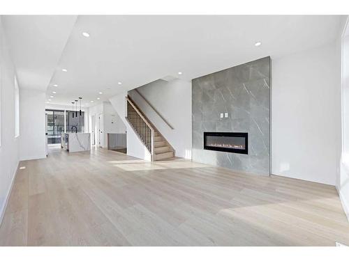 3398 8 Avenue Sw, Calgary, AB - Indoor Photo Showing Other Room With Fireplace