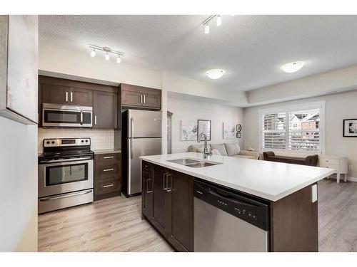 1204-1225 Kings Heights Way Se, Airdrie, AB - Indoor Photo Showing Kitchen With Double Sink