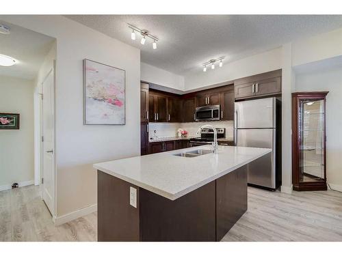 1204-1225 Kings Heights Way Se, Airdrie, AB - Indoor Photo Showing Kitchen With Double Sink