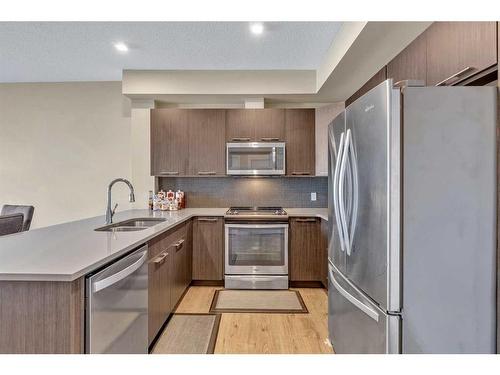 309-214 Sherwood Square Nw, Calgary, AB - Indoor Photo Showing Kitchen With Stainless Steel Kitchen With Double Sink