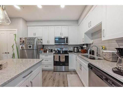 109-150 Shawnee Square Sw, Calgary, AB - Indoor Photo Showing Kitchen With Stainless Steel Kitchen With Double Sink