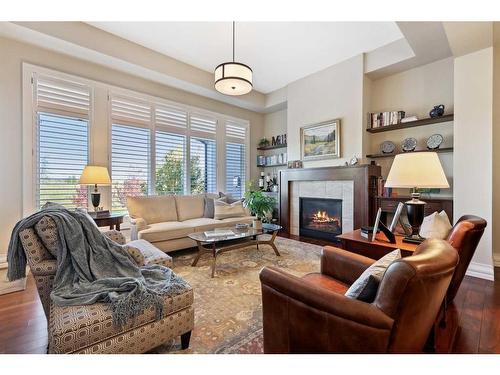 121 Spring Water Close, Heritage Pointe, AB - Indoor Photo Showing Living Room With Fireplace