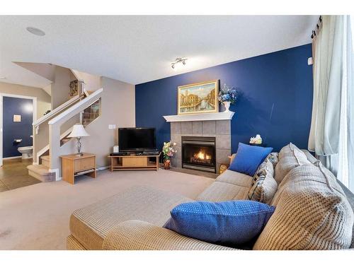 15 Saddletree Drive Ne, Calgary, AB - Indoor Photo Showing Living Room With Fireplace