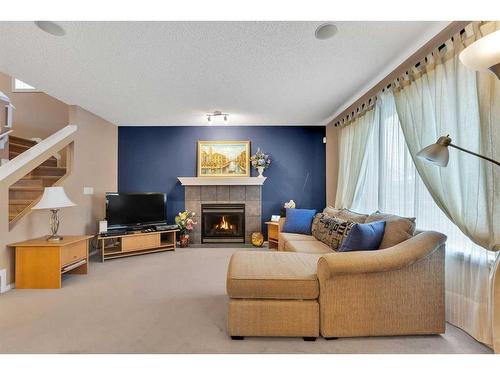 15 Saddletree Drive Ne, Calgary, AB - Indoor Photo Showing Living Room With Fireplace