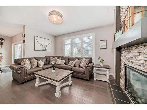 91 Sunset Park, Cochrane, AB - Indoor Photo Showing Living Room With Fireplace