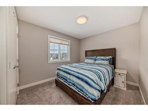 91 Sunset Park, Cochrane, AB - Indoor Photo Showing Bedroom