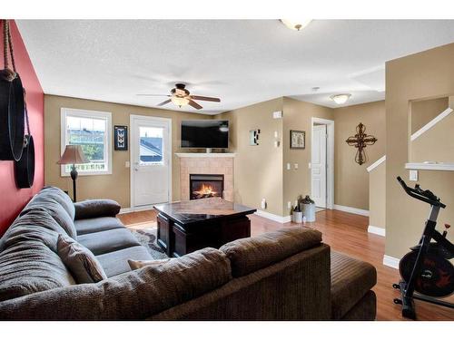 19 Tucker Circle, Okotoks, AB - Indoor Photo Showing Living Room With Fireplace