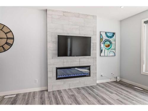 22 Amblehurst Way Nw, Calgary, AB - Indoor Photo Showing Living Room With Fireplace