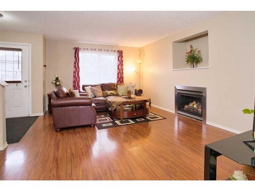 634 Evermeadow Road Sw, Calgary, AB - Indoor Photo Showing Living Room With Fireplace