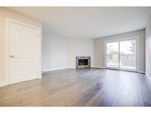 1203-829 Coach Bluff Crescent Sw, Calgary, AB - Indoor Photo Showing Living Room With Fireplace