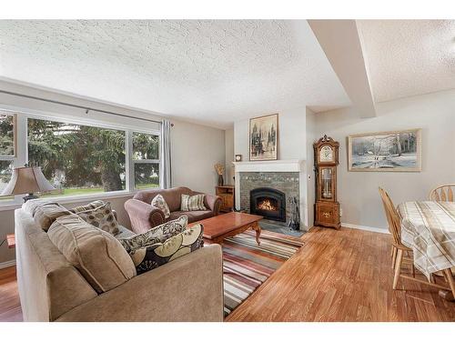 14 Knight Street, Okotoks, AB - Indoor Photo Showing Living Room With Fireplace