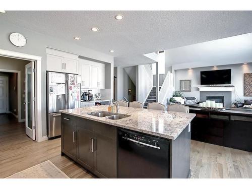 22 Evansborough View Nw, Calgary, AB - Indoor Photo Showing Kitchen With Fireplace With Double Sink With Upgraded Kitchen