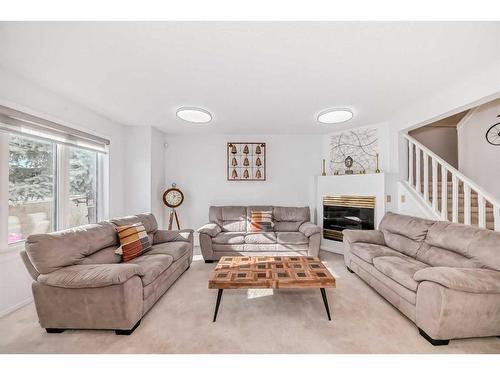 8-388 Sandarac Drive Nw, Calgary, AB - Indoor Photo Showing Living Room With Fireplace