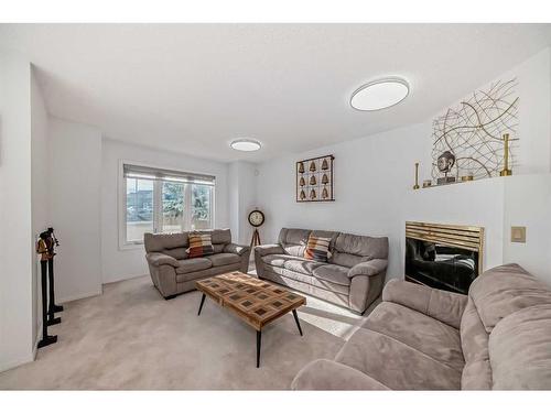 8-388 Sandarac Drive Nw, Calgary, AB - Indoor Photo Showing Living Room With Fireplace