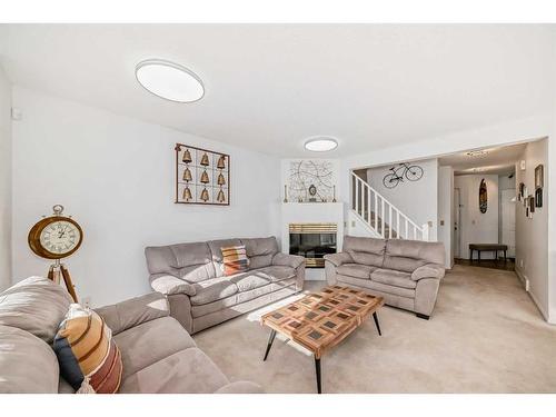 8-388 Sandarac Drive Nw, Calgary, AB - Indoor Photo Showing Living Room With Fireplace