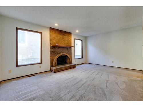 7 Woodmont Way Sw, Calgary, AB - Indoor With Fireplace