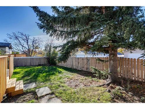 7 Woodmont Way Sw, Calgary, AB - Outdoor With Backyard