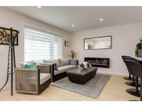 9339 Allison Drive Se, Calgary, AB - Indoor Photo Showing Living Room With Fireplace