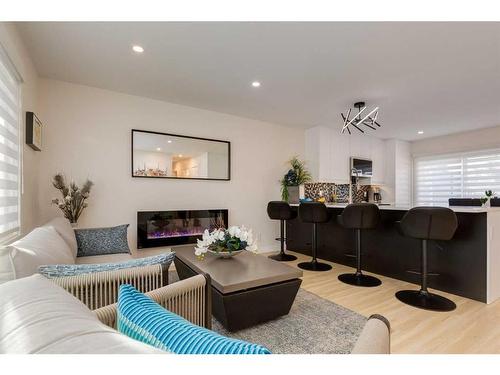 9339 Allison Drive Se, Calgary, AB - Indoor Photo Showing Living Room With Fireplace