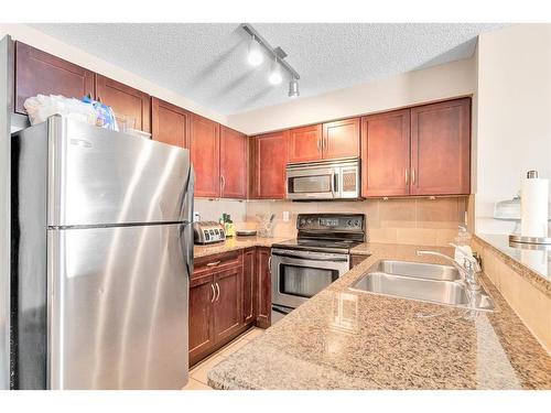 5210-69 Country Village Manor Ne, Calgary, AB - Indoor Photo Showing Kitchen With Stainless Steel Kitchen With Double Sink