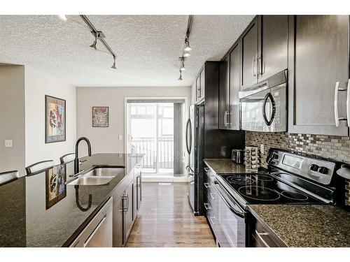 610 Cranford Court Se, Calgary, AB - Indoor Photo Showing Kitchen With Double Sink With Upgraded Kitchen