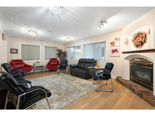 3153-1818 Simcoe Boulevard Sw, Calgary, AB - Indoor Photo Showing Living Room With Fireplace