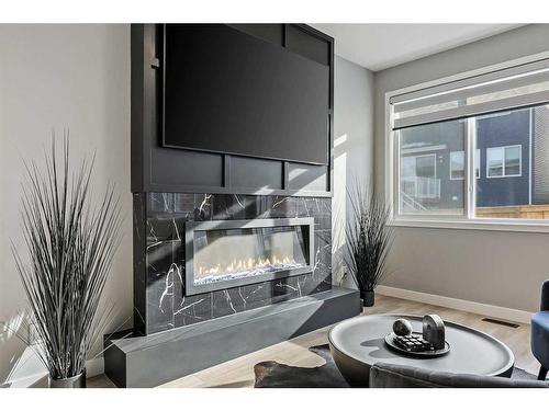 145 Edith Villas Nw, Calgary, AB - Indoor Photo Showing Living Room With Fireplace