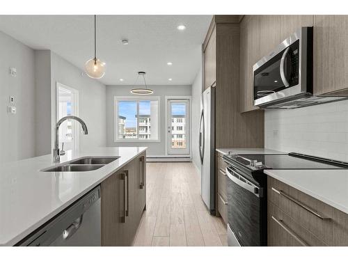 4413-111 Wolf Creek Drive Se, Calgary, AB - Indoor Photo Showing Kitchen With Double Sink With Upgraded Kitchen