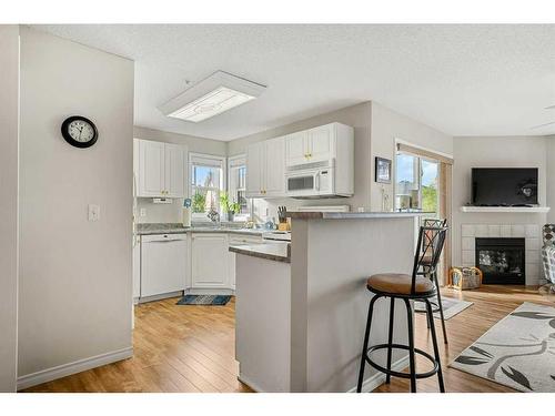 2202 Tuscarora Manor Nw, Calgary, AB - Indoor Photo Showing Kitchen With Fireplace