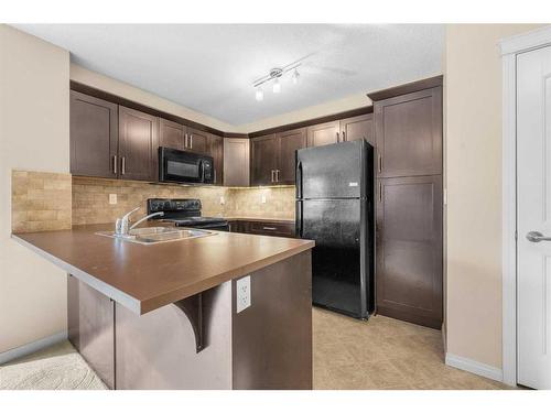 1207-130 Panatella Street Nw, Calgary, AB - Indoor Photo Showing Kitchen With Double Sink