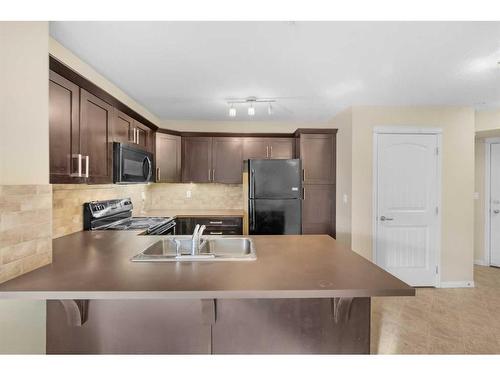 1207-130 Panatella Street Nw, Calgary, AB - Indoor Photo Showing Kitchen With Double Sink