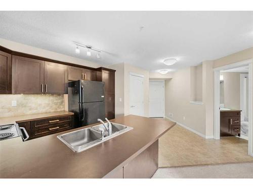 1207-130 Panatella Street Nw, Calgary, AB - Indoor Photo Showing Kitchen With Double Sink