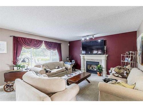 242 Coville Circle Ne, Calgary, AB - Indoor Photo Showing Living Room With Fireplace