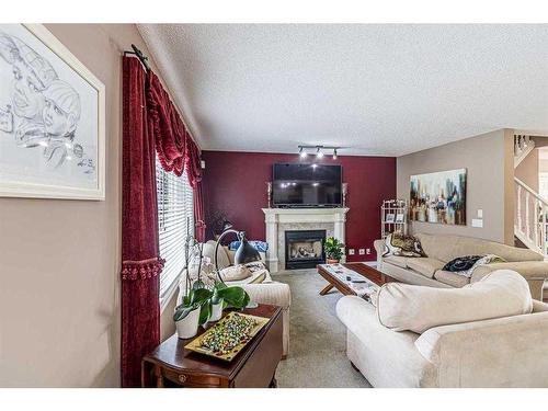 242 Coville Circle Ne, Calgary, AB - Indoor Photo Showing Living Room With Fireplace