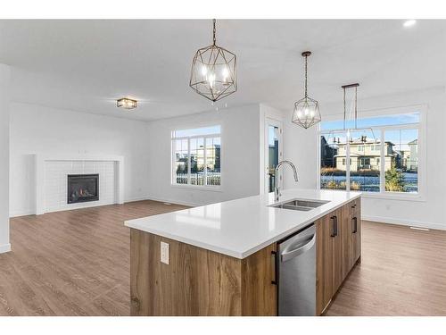 230 Kinniburgh Loop, Chestermere, AB - Indoor Photo Showing Kitchen With Fireplace With Double Sink With Upgraded Kitchen