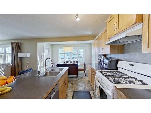 9 Prairie Springs Close Sw, Airdrie, AB - Indoor Photo Showing Kitchen With Double Sink