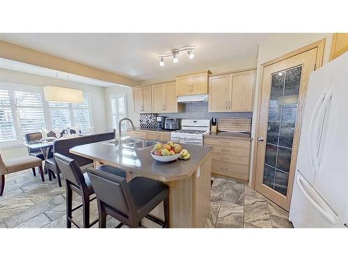 9 Prairie Springs Close Sw, Airdrie, AB - Indoor Photo Showing Kitchen With Double Sink