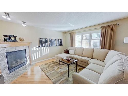 9 Prairie Springs Close Sw, Airdrie, AB - Indoor Photo Showing Living Room With Fireplace