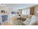 9 Prairie Springs Close Sw, Airdrie, AB  - Indoor Photo Showing Living Room With Fireplace 