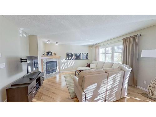 9 Prairie Springs Close Sw, Airdrie, AB - Indoor Photo Showing Living Room With Fireplace