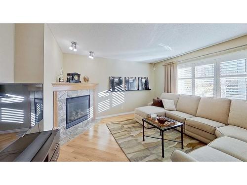 9 Prairie Springs Close Sw, Airdrie, AB - Indoor Photo Showing Living Room With Fireplace