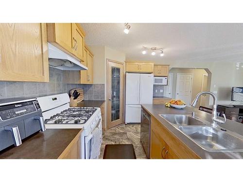 9 Prairie Springs Close Sw, Airdrie, AB - Indoor Photo Showing Kitchen With Double Sink