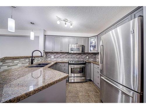 1304-8810 Royal Birch Boulevard Nw, Calgary, AB - Indoor Photo Showing Kitchen With Double Sink With Upgraded Kitchen