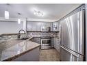 1304-8810 Royal Birch Boulevard Nw, Calgary, AB  - Indoor Photo Showing Kitchen With Double Sink With Upgraded Kitchen 